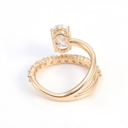 Oval cut moissanite engagement ring set in solid 14K rose gold featuring a curved diamond wedding band and solitaire center stone.