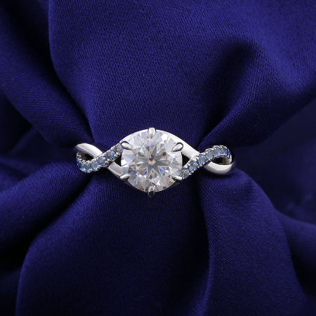 round brilliant moissanite engagement ring with blue sapphire accent in solid white gold