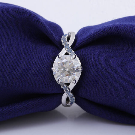 round brilliant moissanite engagement ring with blue sapphire accent in solid white gold
