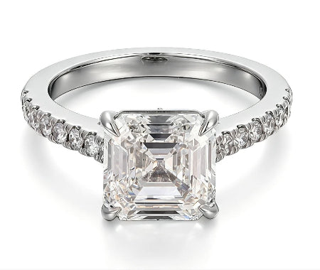Emerald cut moissanite engagement ring in solid 14K white gold featuring a hidden baguette halo and pavé diamond accent band