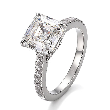 Emerald cut moissanite engagement ring in solid 14K white gold featuring a hidden baguette halo and pavé diamond accent band