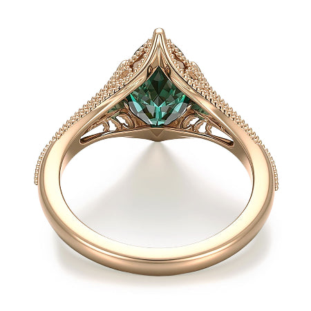 green marquise cut moissanite engagement ring in yellow gold with vintage split shank and accent diamonds worn on finger.