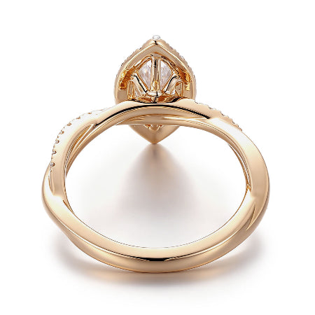 Marquise cut moissanite halo engagement ring in solid 14K yellow gold featuring a twisted pavé band and sparkling halo setting