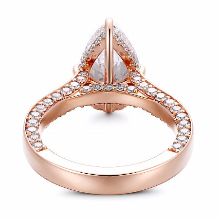pear cut moissanite engagement ring in solid 14k rose gold featuring pavé accents and engraved leaf details in a nature-inspired solitaire setting.