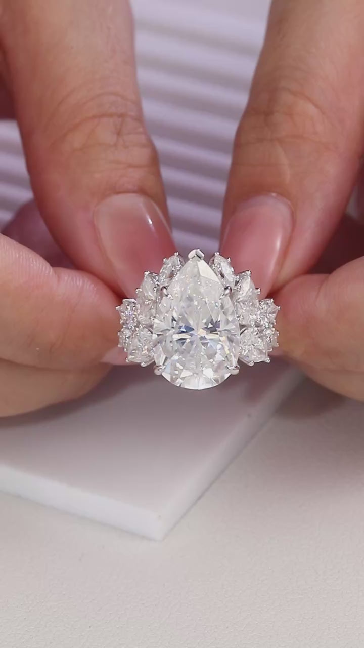 Large trillion cut moissanite engagement ring in 925 sterling silver with pear and round moissanite floral cluster side stones