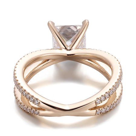 princess cut moissanite engagement ring with a split shank crossover pavé diamond band in solid rose gold. elegant solitaire bridal ring for women.