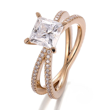 princess cut moissanite engagement ring with a split shank crossover pavé diamond band in solid rose gold. elegant solitaire bridal ring for women.