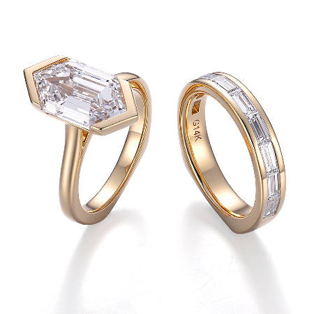 shield cut moissanite engagement ring set in solid 14k yellow gold featuring a bezel-set geometric center stone and matching baguette wedding band