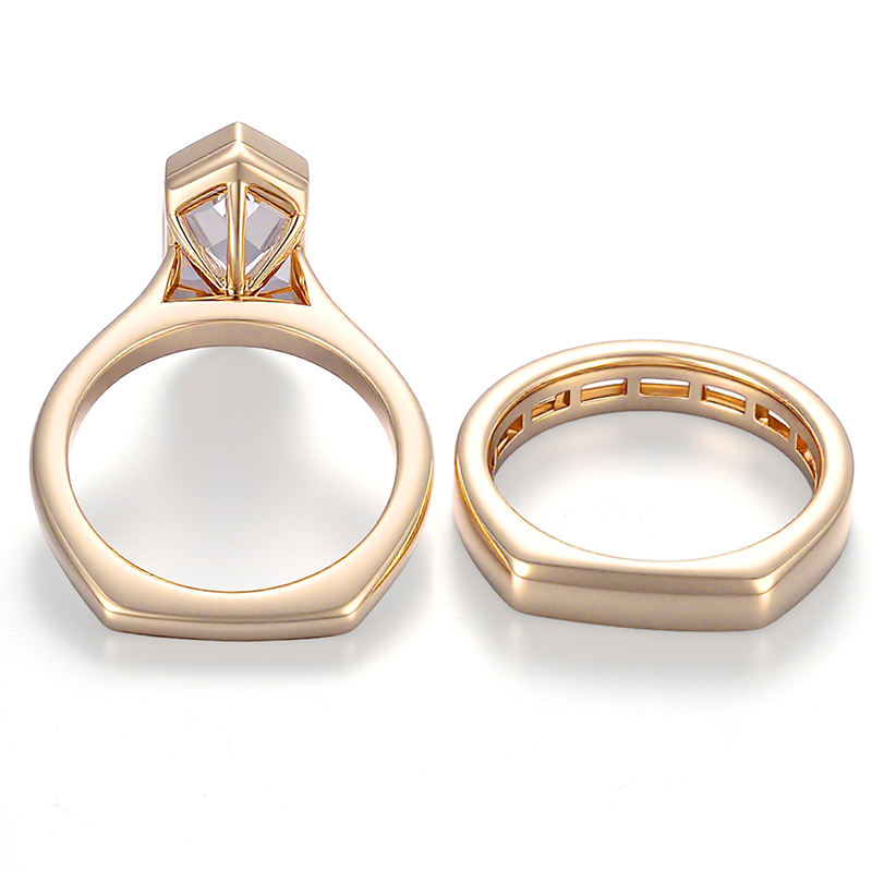 shield cut moissanite engagement ring set in solid 14k yellow gold featuring a bezel-set geometric center stone and matching baguette wedding band