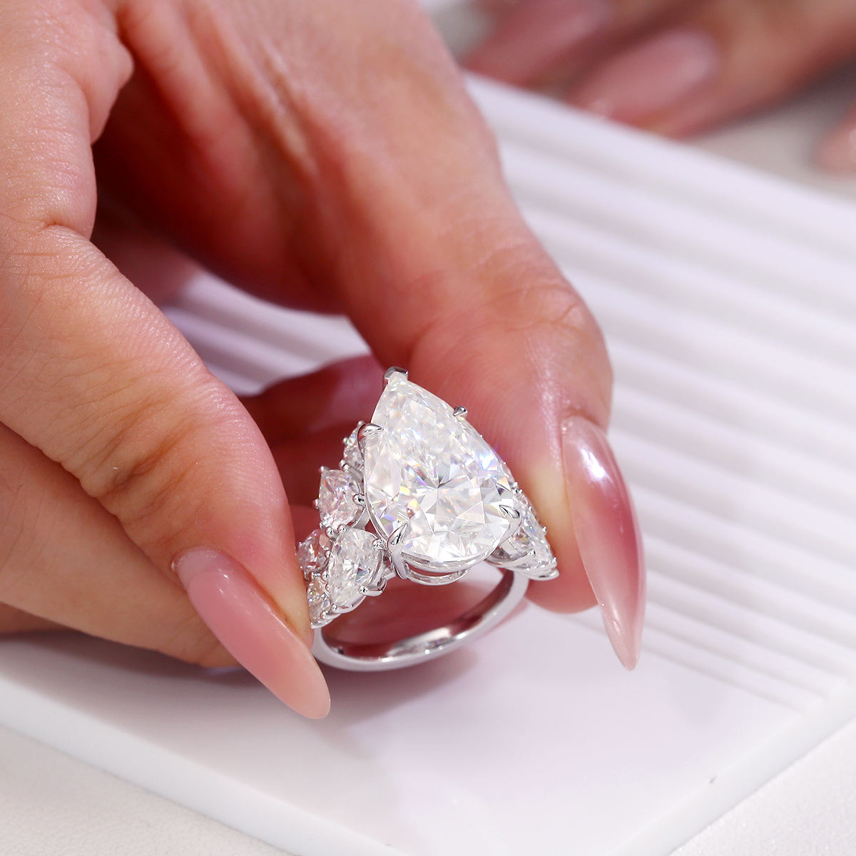 Large trillion cut moissanite engagement ring in 925 sterling silver with pear and round moissanite floral cluster side stones